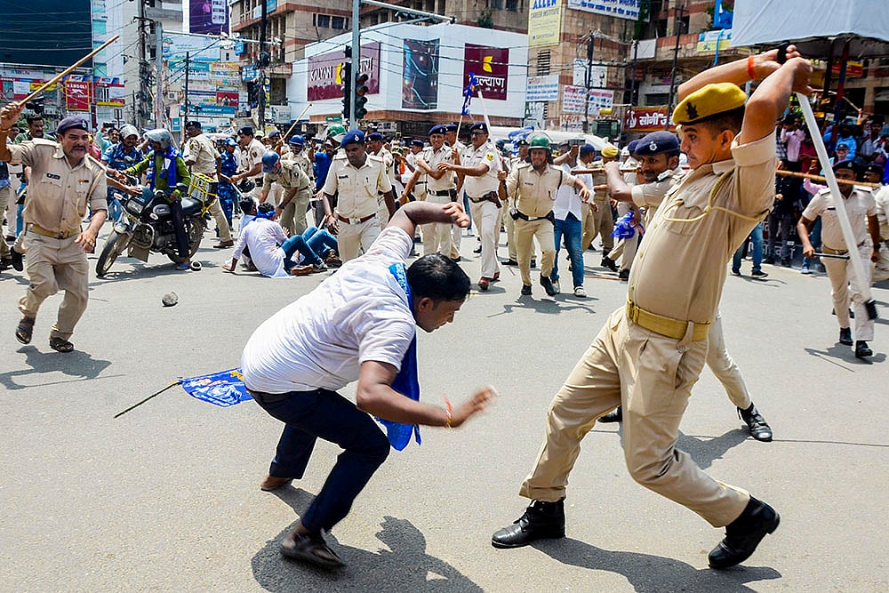 | Photo: PTI : Bharat Bandh: Police personnel lathi-charge protestors in Patna